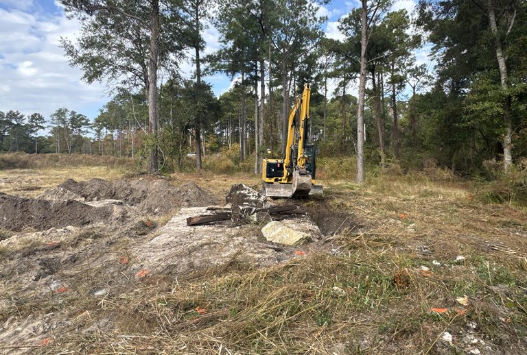 A contractor working for the Multistate Trust operates an excavator Nov. 7 to remove contaminated debris from the former treated and untreated wood storage area at the Kerr-McGee Navassa Superfund Site. The additional cleanup of contaminated soil and debris in Operable Unit 2 got going Nov. 3. Photo: Multistate Trust