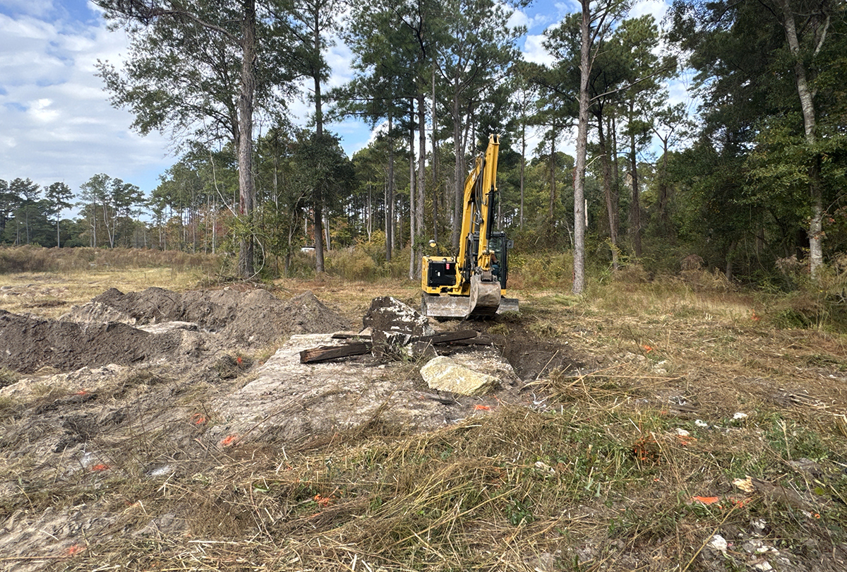 A contractor working for the Multistate Trust operates an excavator Nov. 7 to remove contaminated debris from the former treated and untreated wood storage area at the Kerr-McGee Navassa Superfund Site. The additional cleanup of contaminated soil and debris in Operable Unit 2 got going Nov. 3. Photo: Multistate Trust 